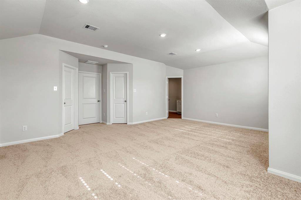 The expansive, primary bedroom is the perfect place to relax after a long day.