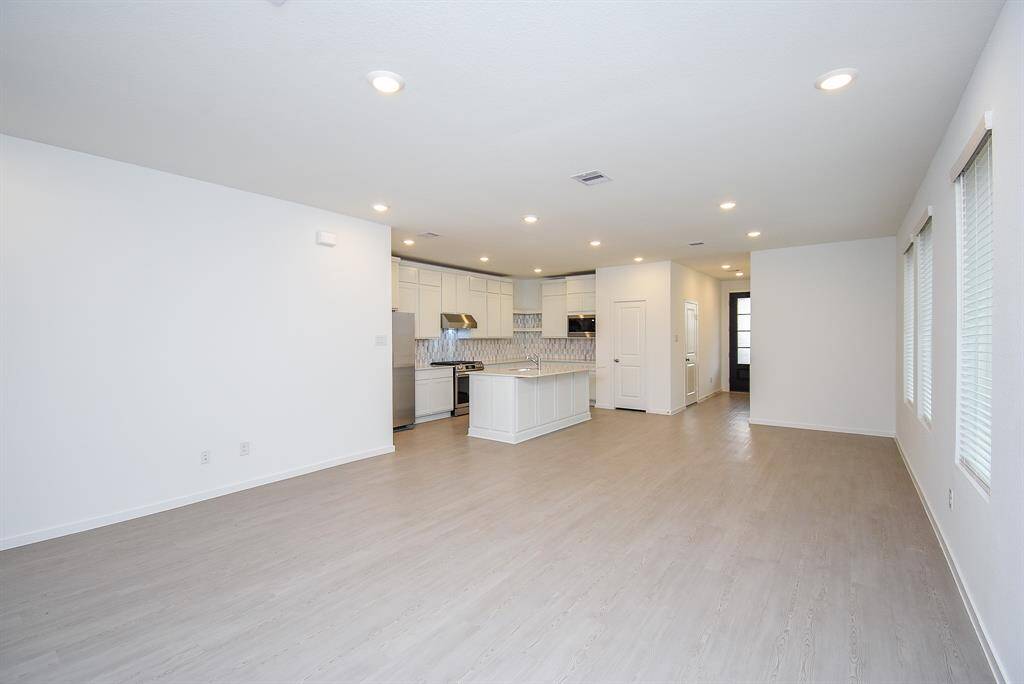 Spacious and inviting bedroom with stylish decor and abundant natural light.
