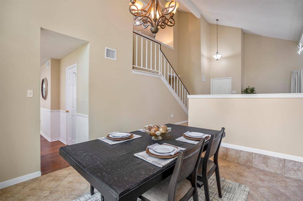 Standing near the sliding glass door, you can easily see the kitchen entry to the left and, across the formal living room, the front door—showcasing the open flow and thoughtful design throughout the main living areas.