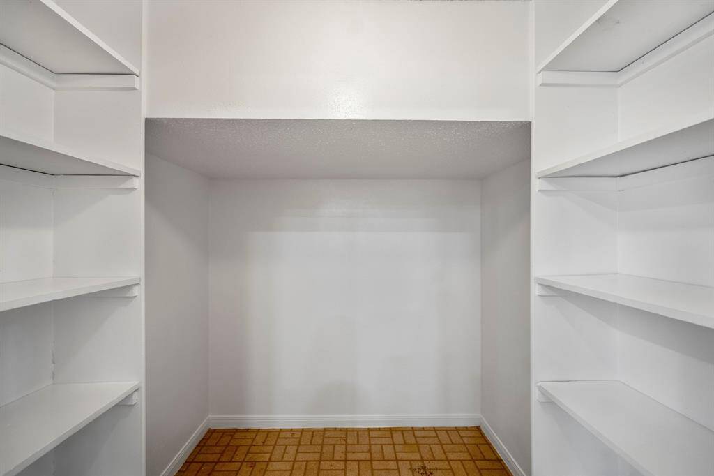 Discover the spacious pantry tucked below the stairs, offering ample storage to keep your kitchen organized and clutter-free.