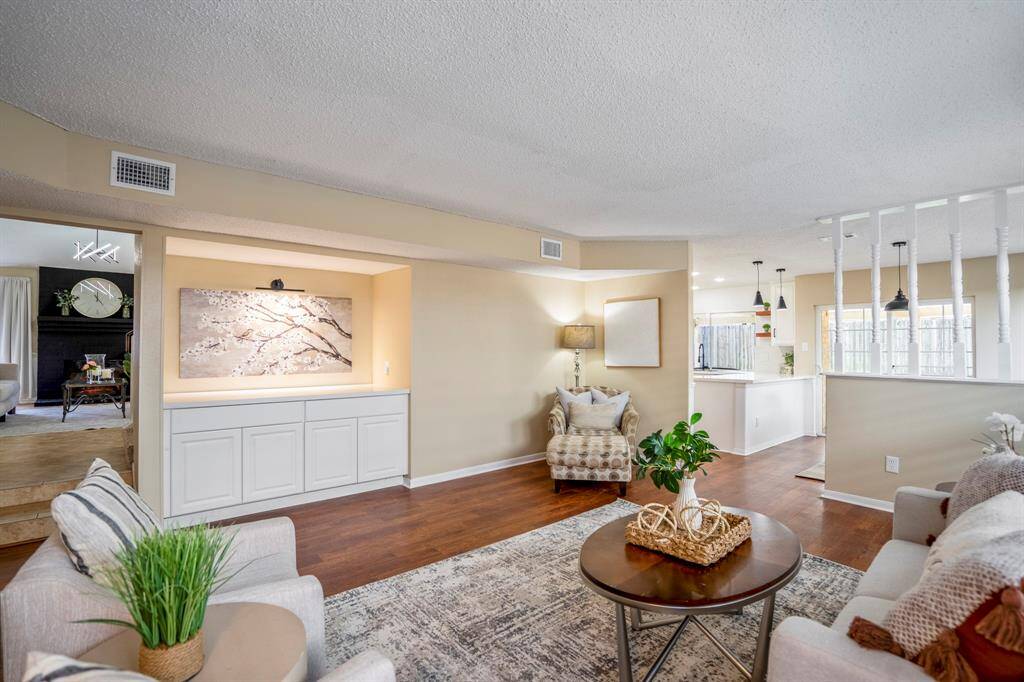 From this vantage point in the living area, you can glimpse the formal living room up the steps through the doorway to the left, while to the right, the breakfast nook and kitchen invite casual gatherings. This open layout creates a perfect balance of spaces to relax, entertain, and connect throughout your day.
