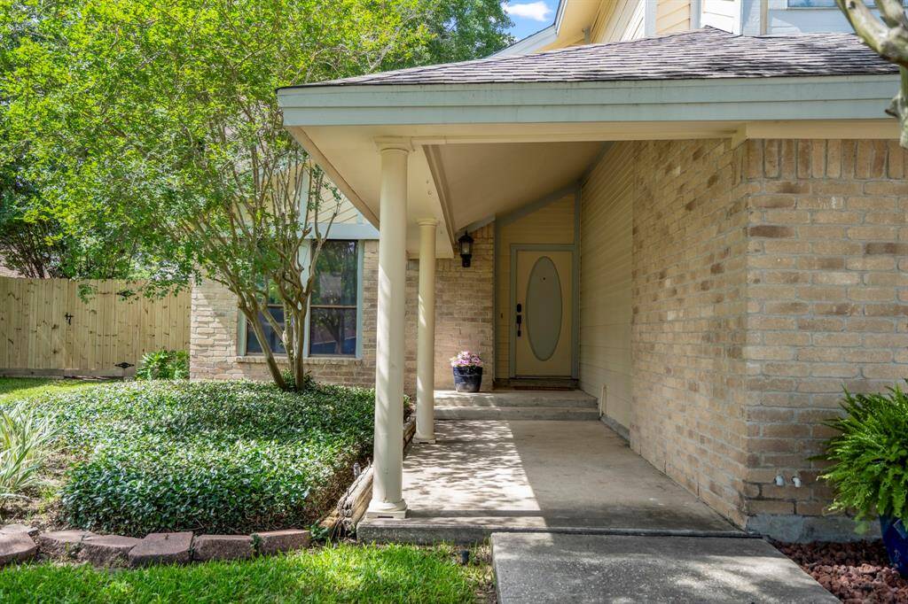 As you make your way to the front door, the covered porch offers a welcoming first impression—perfect for seasonal décor or a quiet moment with your morning coffee.