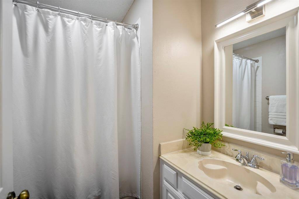 The upstairs full bathroom features a jetted tub and shower combo, offering a relaxing and functional space for everyday comfort.