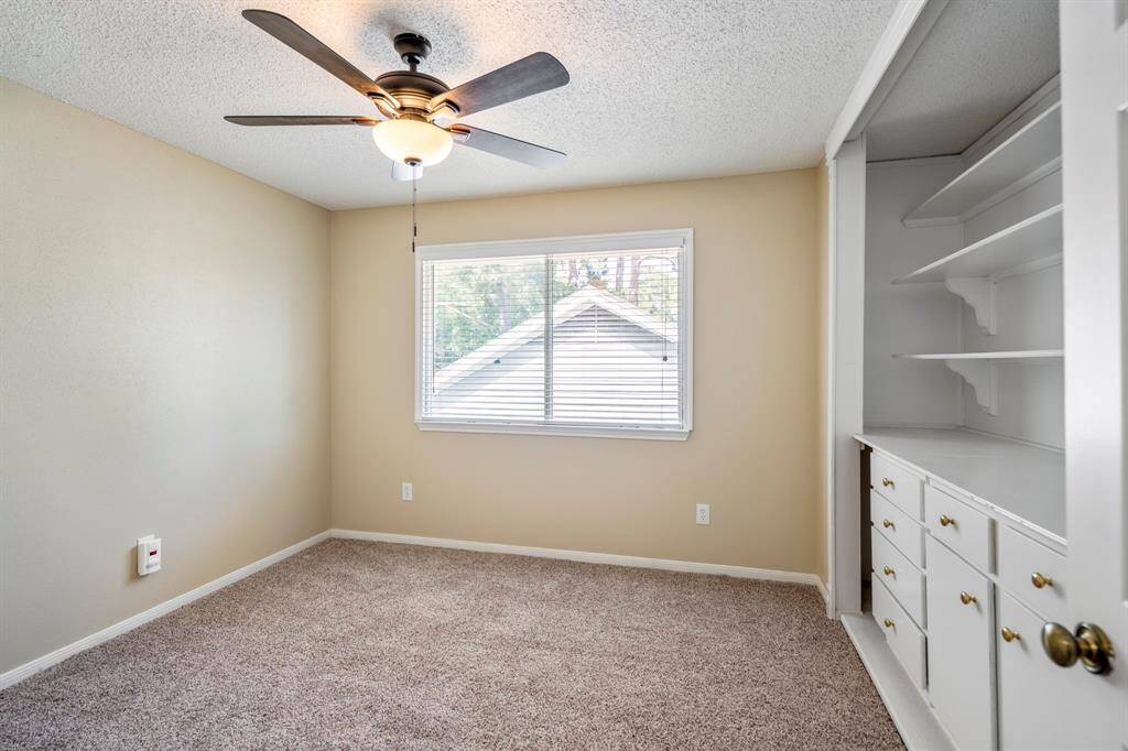 This upstairs bedroom’s closet is thoughtfully designed with a built-in dresser and shelving, providing organized storage and easy access for your belongings.