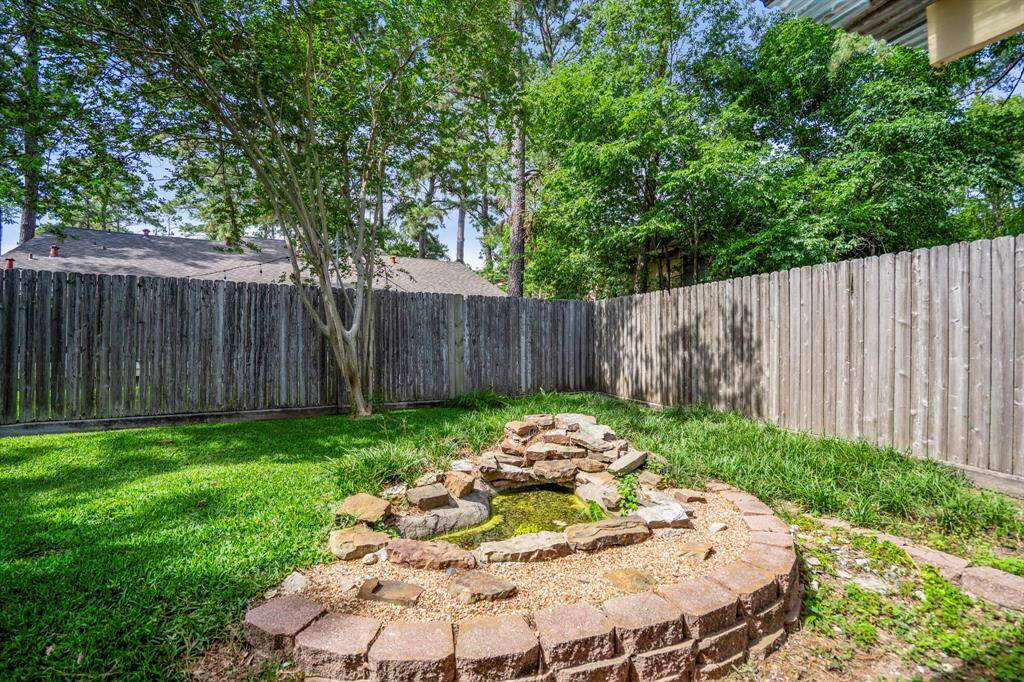 Just beyond the covered patio, discover a charming fountain and pond area framed by beautiful stonework. With a little vision and care, this spot could become a peaceful focal point of the backyard—perfect for adding character and a sense of retreat.