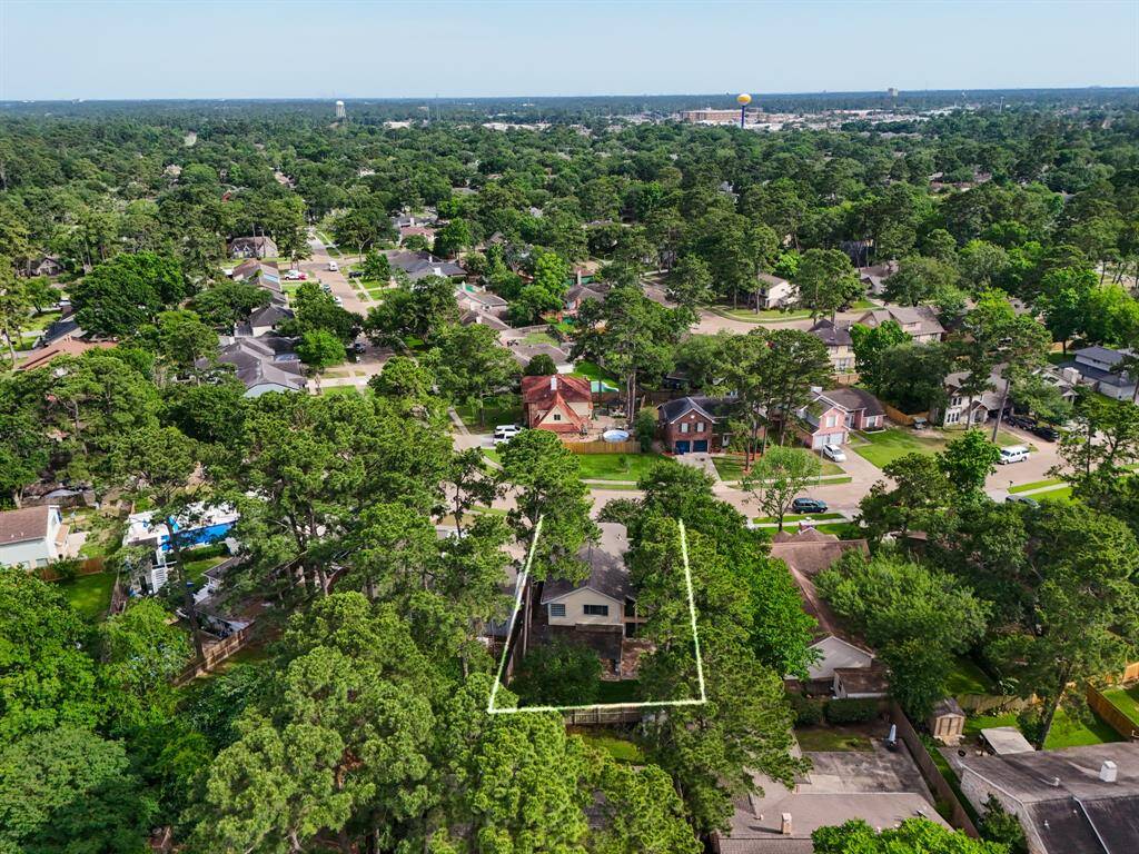 From farther above, this aerial view highlights the full extent of the backyard and surrounding lot lines, giving you a sense of space and privacy. You can also see how the home is thoughtfully positioned within the neighborhood, with mature trees and well-maintained homes all around.