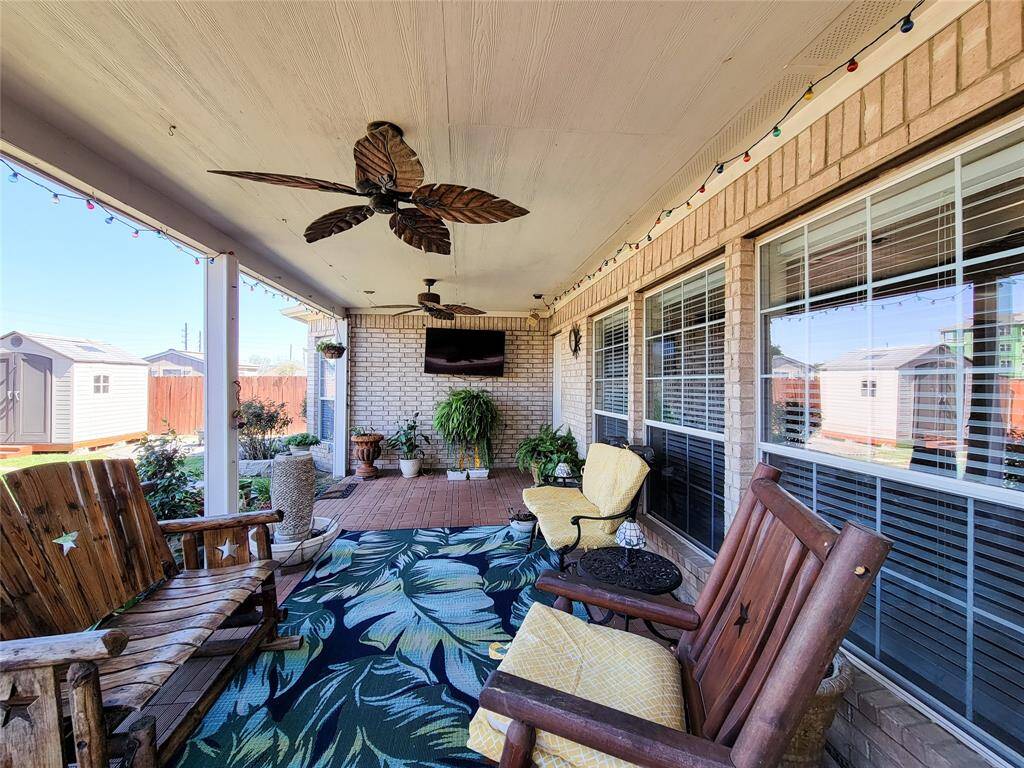 Surrounded by a well-kept garden and a wooden fence, it offers a cozy atmosphere.