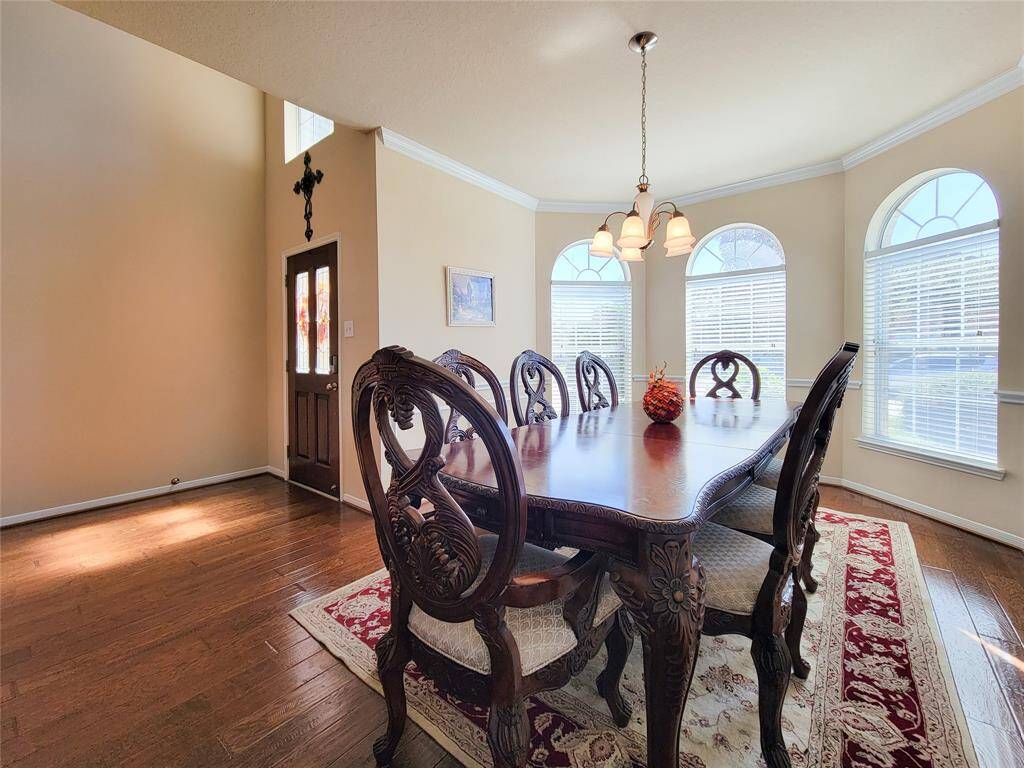 This dining room features abundant natural light from three arched windows.
