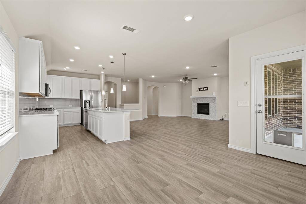 Look from dining space into family room/ kitchen