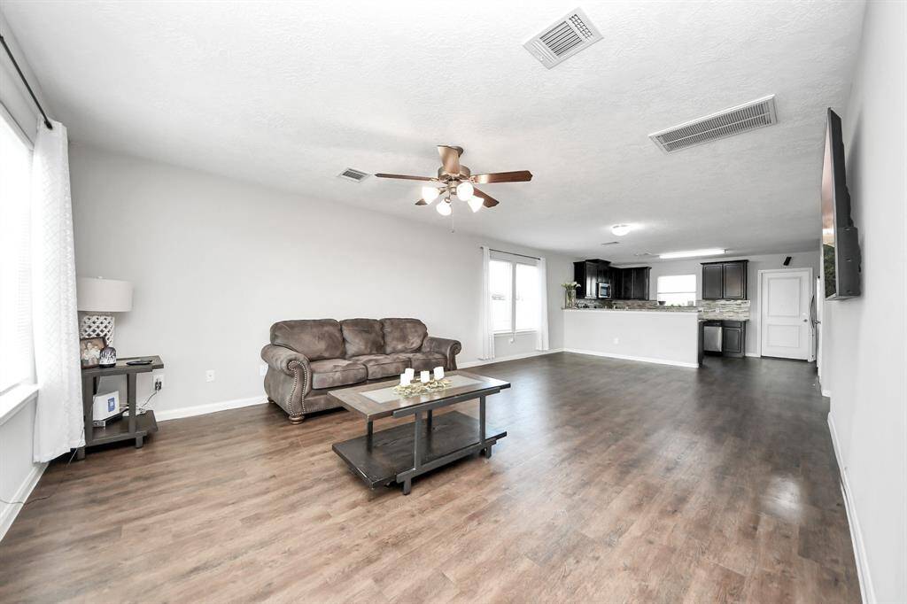 The open concept design seamlessly connects it to the kitchen and dining area, fostering an atmosphere of togetherness.