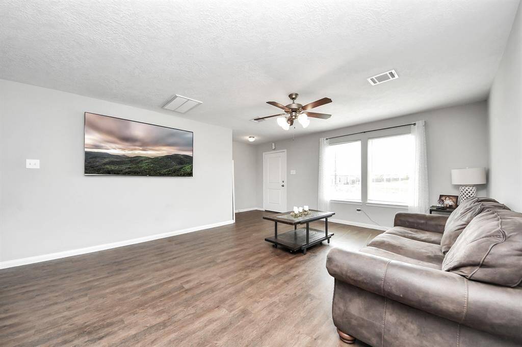 The heart of the home, this spacious living room offers a warm and inviting ambianceconnects it to the kitchen and dining area, fostering an atmosphere of togetherness.