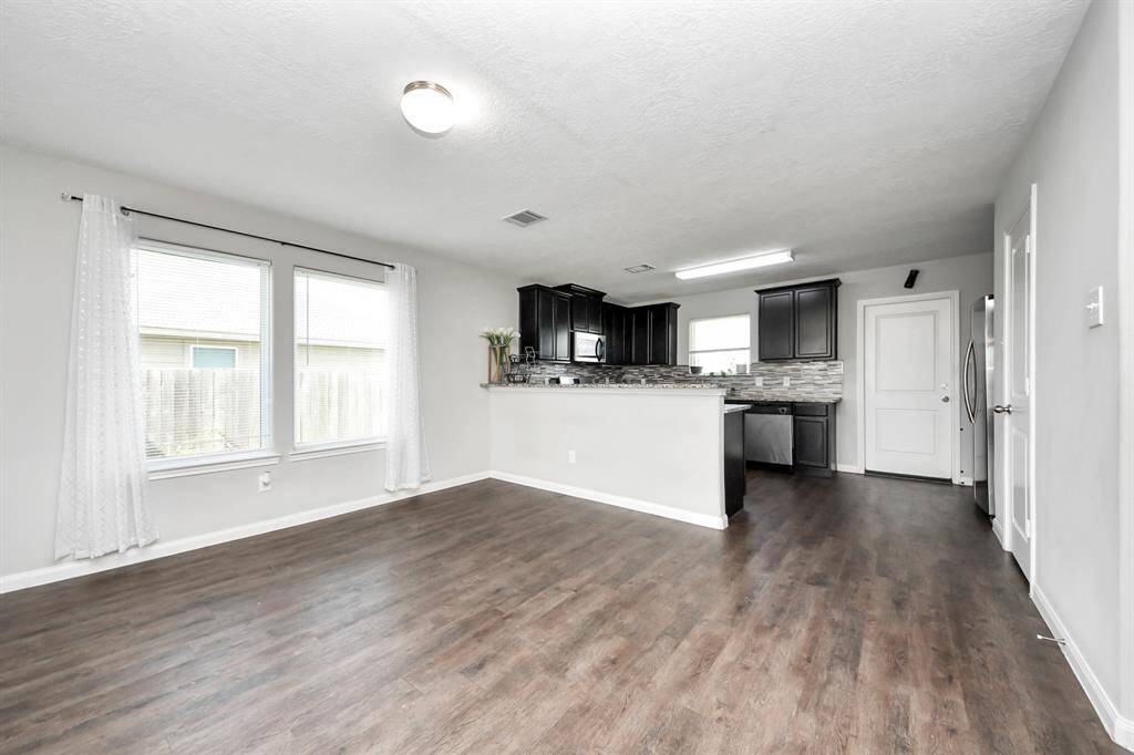 The open concept design seamlessly connects it to the kitchen and dining area, fostering an atmosphere of togetherness.