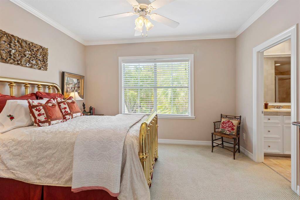 Upstairs bedroom with warm tones, featuring a large double window brings in natural light.  This room host a private bath with lots of storage and a large closet.