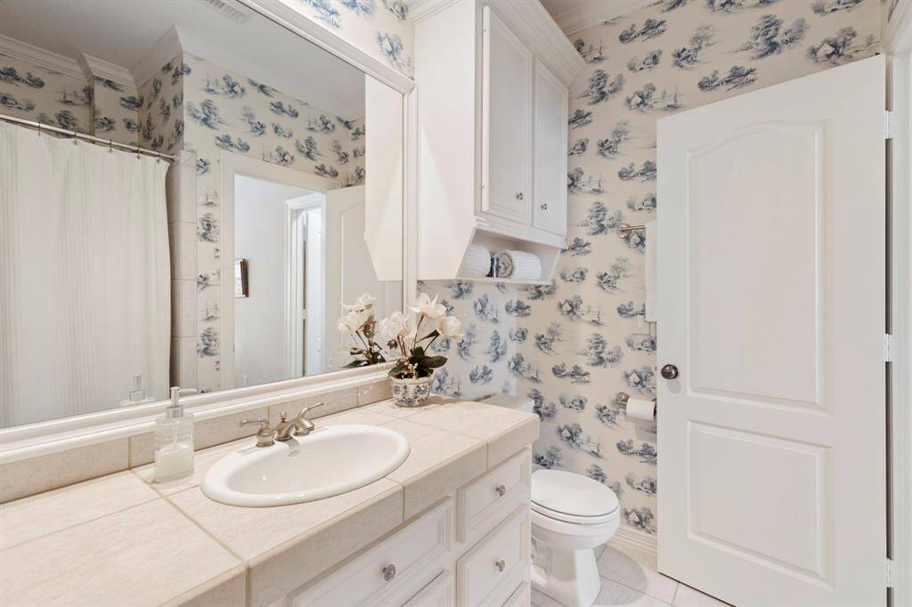 Blue and white bathroom  adjoining bedroom