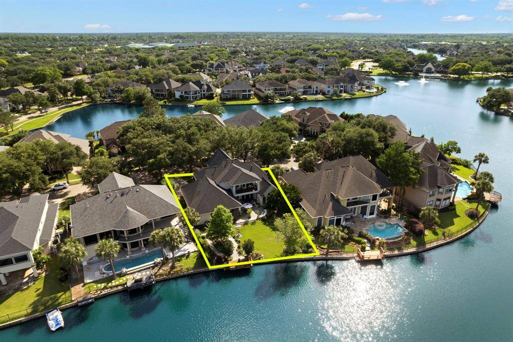 Aerial view of the home and the lake in Waters of Avalon