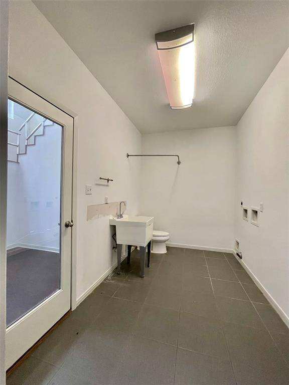 Utility room with half bath.