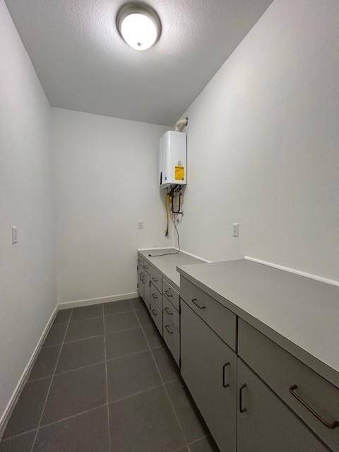 Storage room with tankless waterheater.