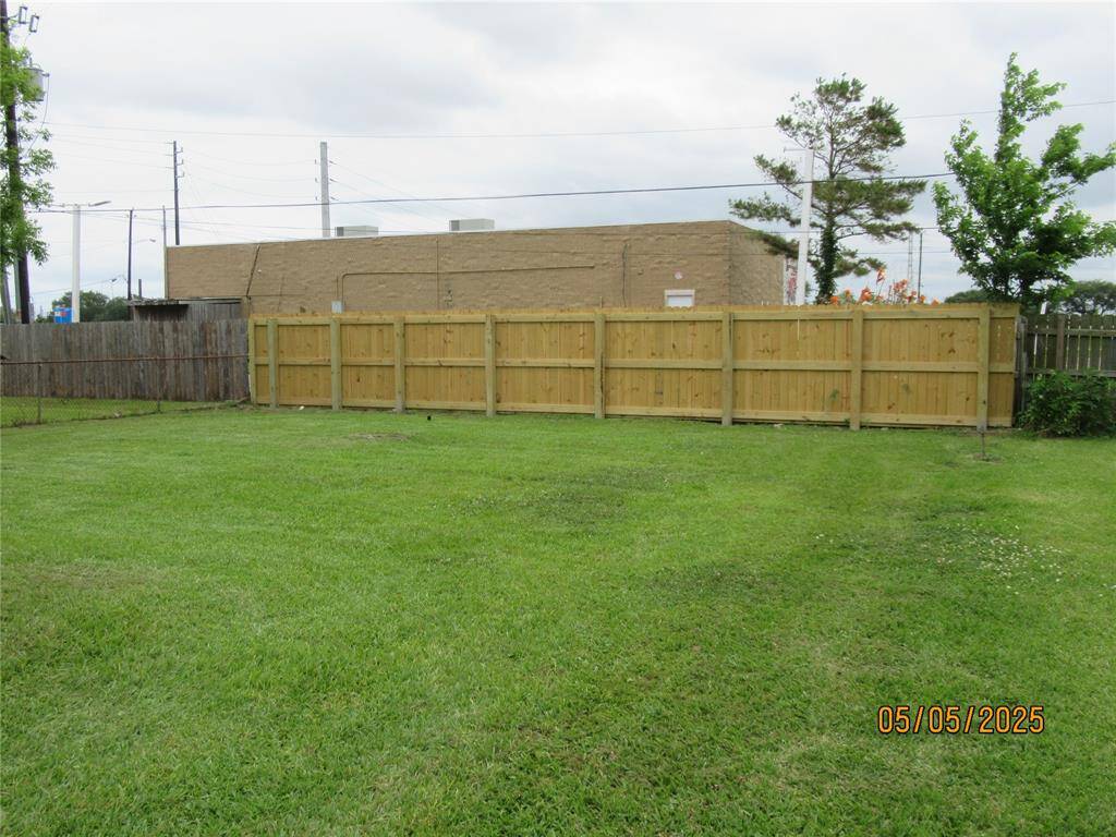 Partial wood fence in backyard.