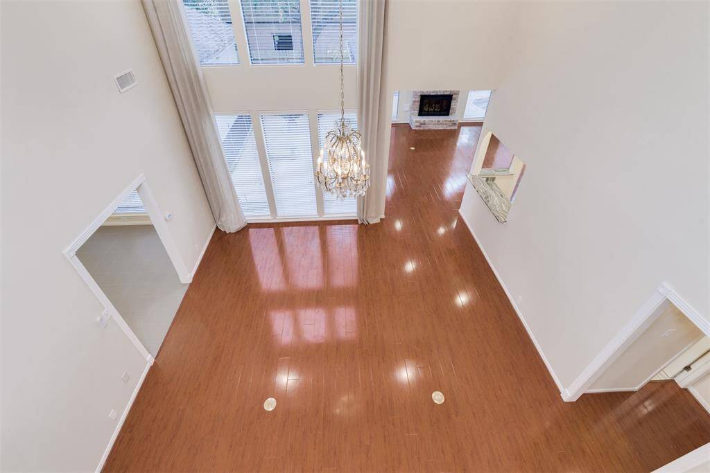 View of the formal living room from above. Great entertaining home with two living rooms downstairs, one with a fireplace, and this one has floor to ceiling windows overlooking the courtyard.