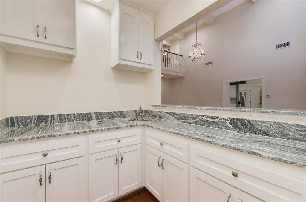 The built in wet bar joins the two living rooms, providing a a space for entertaining and serving beverages.