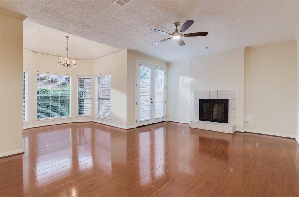 The downstairs master is an executive suite with fireplace and separate sitting area with hardwood floors and crown molding.
