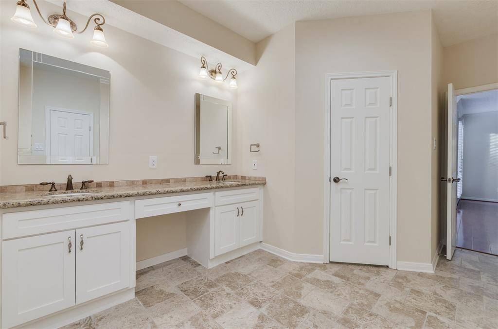 En suite master bathroom has been updated with Travertine floors, new cabinets and Granite counters.