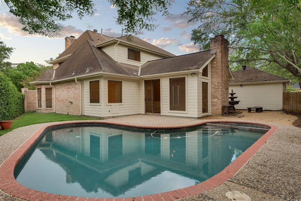 Cool off during Houston summers in the private swimming pool located on the side of this home.
