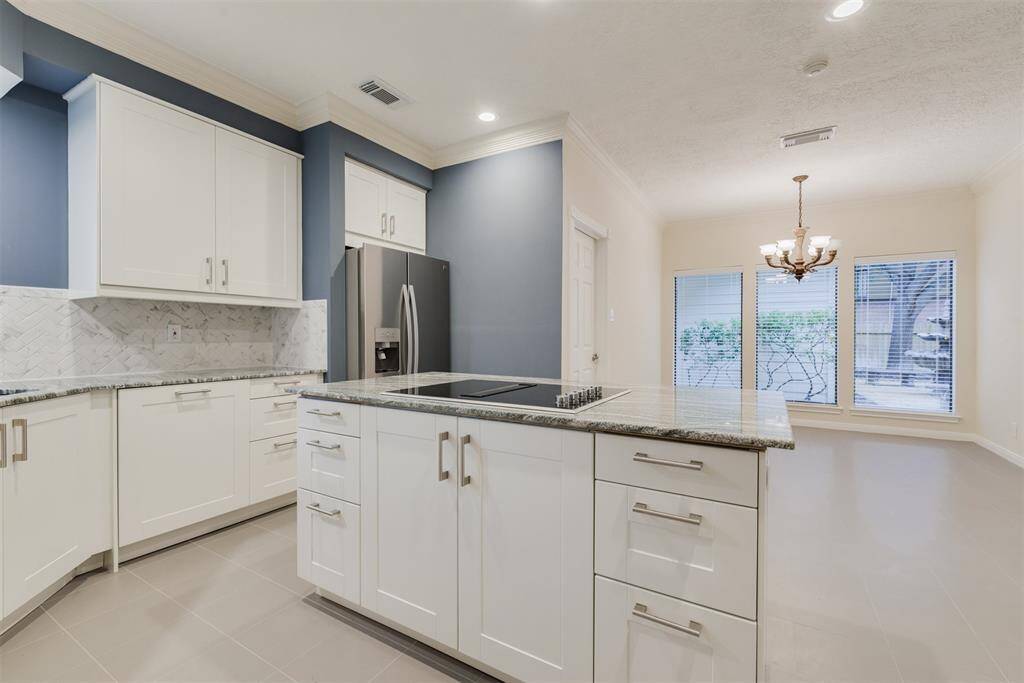 Lots of extra storage in the island with cooktop.