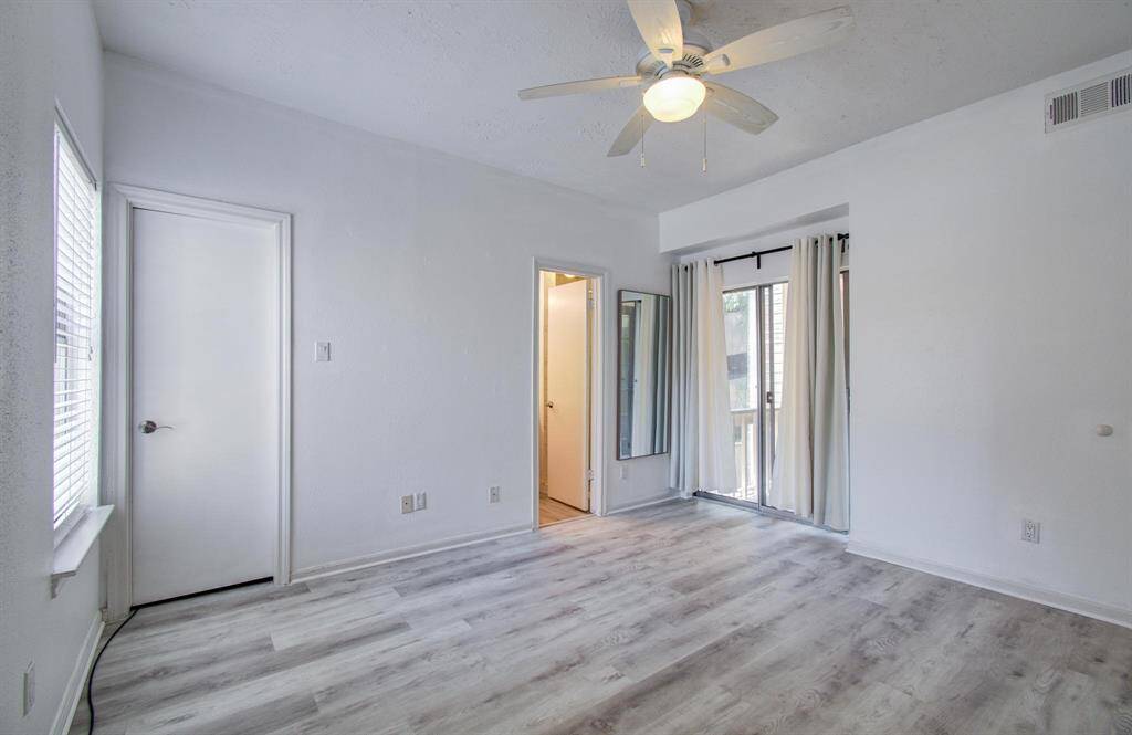 Primary bedroom with ensuite bath, walk in closet, and access to the 2nd balcony