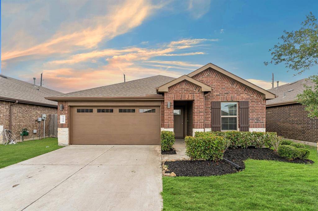 The front yard offers a welcoming first impression with its well-maintained landscaping and expansive driveway
