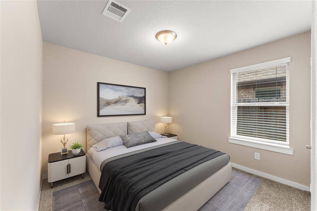 This spacious second bedroom offers plenty of natural light and a peaceful atmosphere, making it perfect for family members or guests.