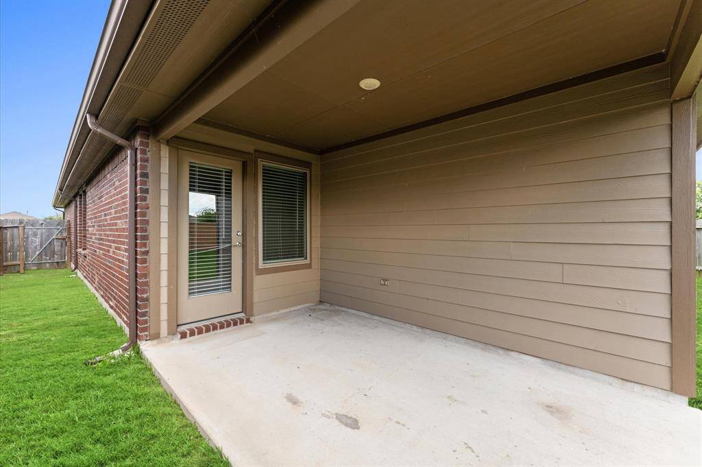 The covered patio offers the perfect space to enjoy the outdoors year-round.