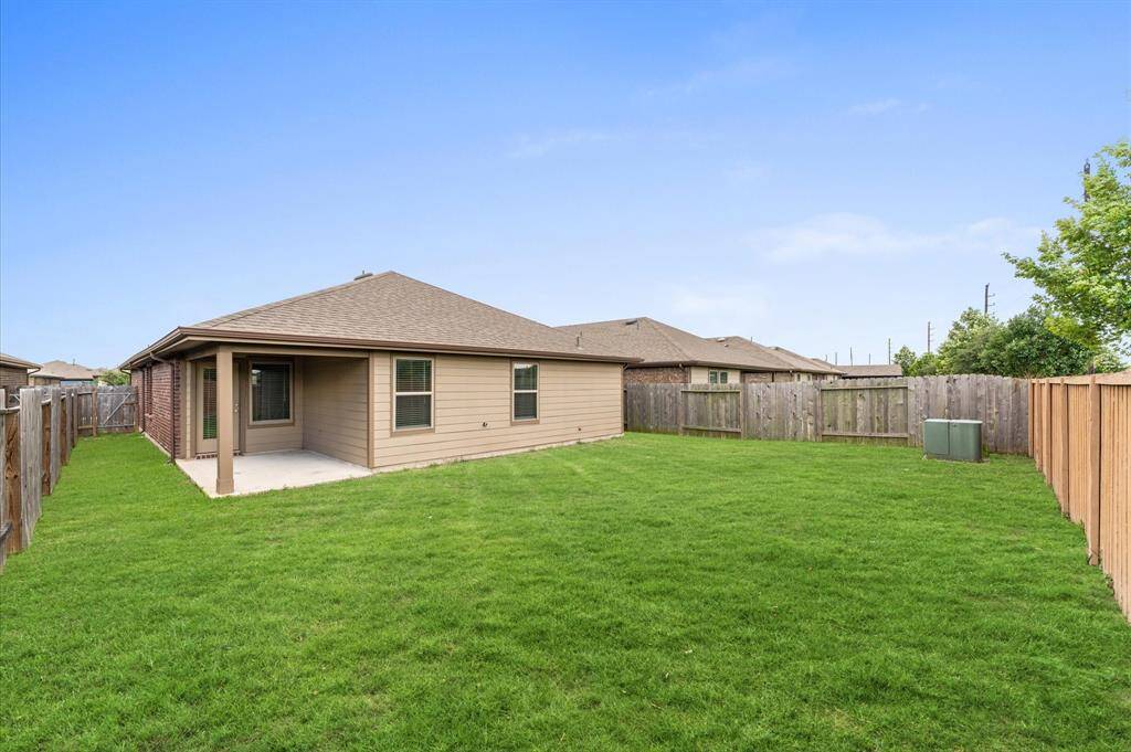 Step outside into the spacious backyard, where the possibilities are endless.