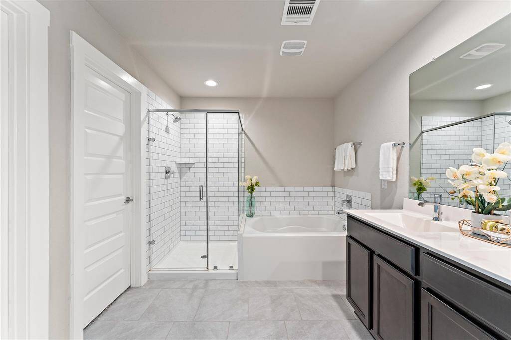 Indulge in the spa-like master bathroom, featuring a separate tub and shower designed for ultimate relaxation.
