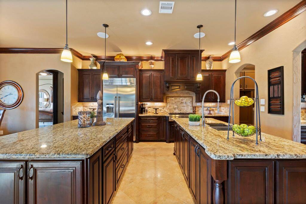 Double Islands and Thermador appliances set the stage for this Gourmet kitchen.