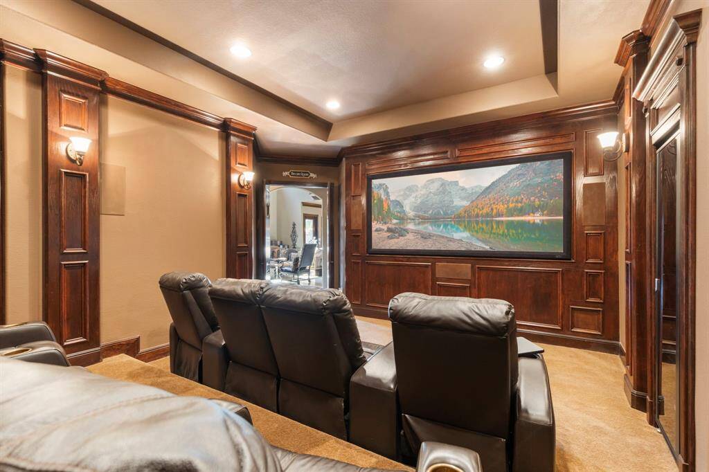 Downstairs Media Room is complete with Rear projector & big screen, Control 4 AV equipment, and reclining seating for 8.