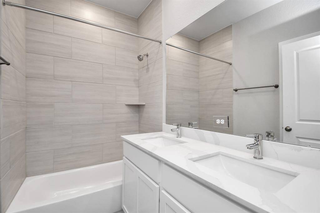 Double sinks and a tub/shower and additional storage in the seconday bath.