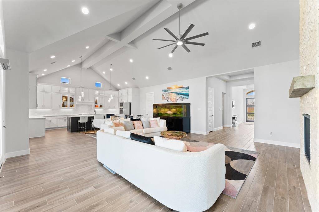 Another view of the spacious and modern open-plan living area high ceilings and recessed lighting.