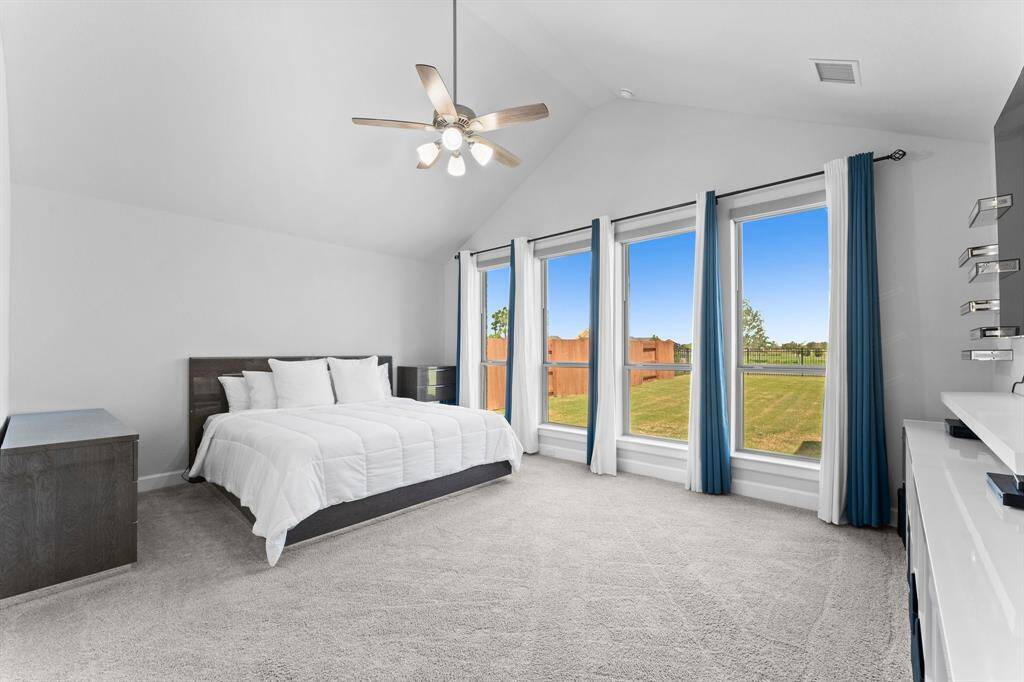 Peaceful Master bedroom with, an expansive window view of the backyard, providing plenty of natural light.