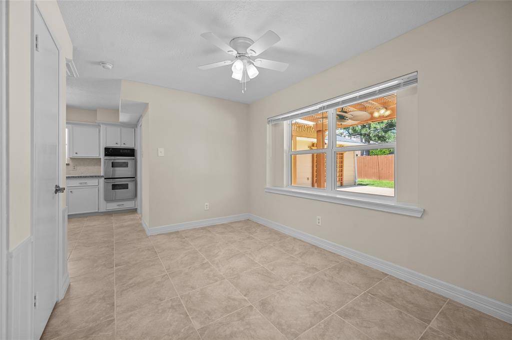 Cozy dining area with tile flooring, lots of light and direct access to the kitchen.