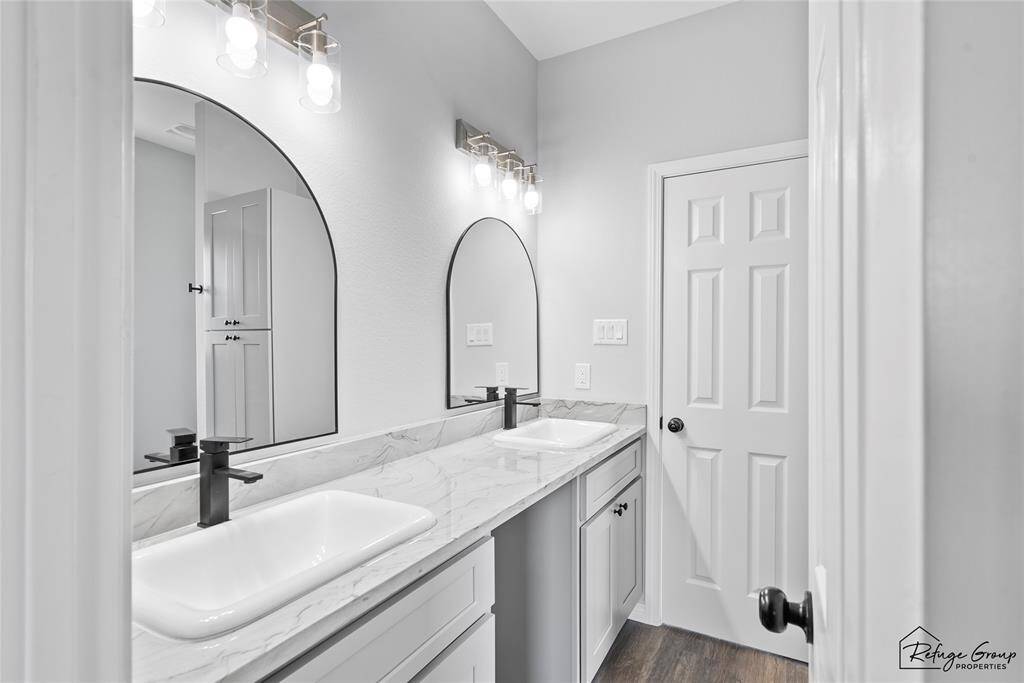 Jack and Jill Bathroom from Bed 1 with double sinks and granite countertop