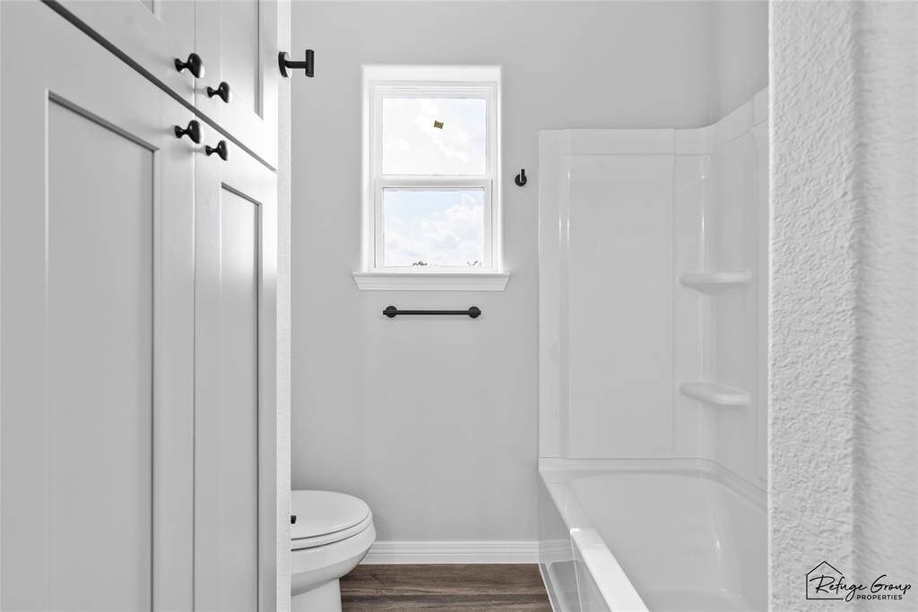 Shower/Tub Combo and a linen closet in bathroom