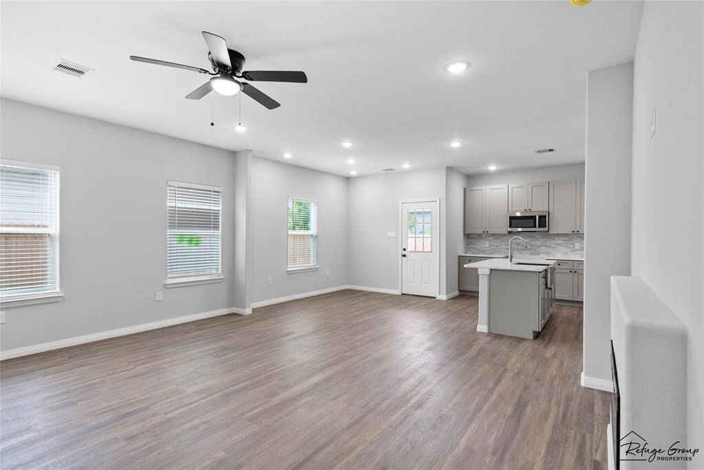 A view from bottom of stairs into the living room and dining room
