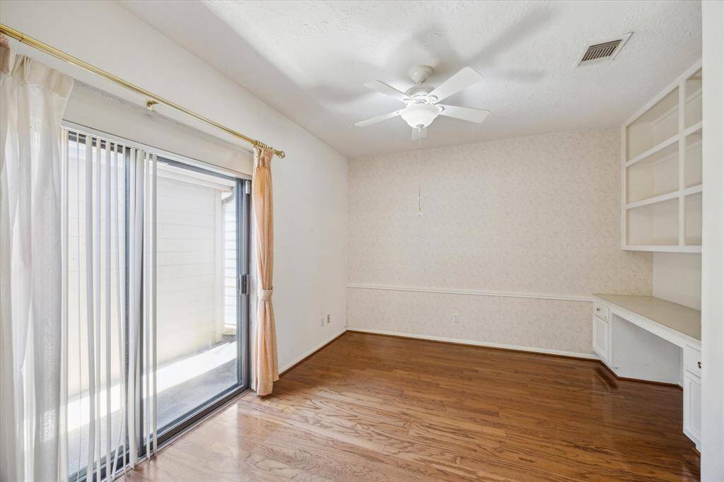 Bright Breakfast area or living space featuring hardwood floors, an open kitchen with stainless steel appliances, and sliding glass doors leading to a patio area. Perfect for entertaining and family gatherings.