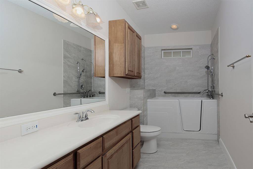 Secondary Bathroom #3 with walk-in tub and shower
