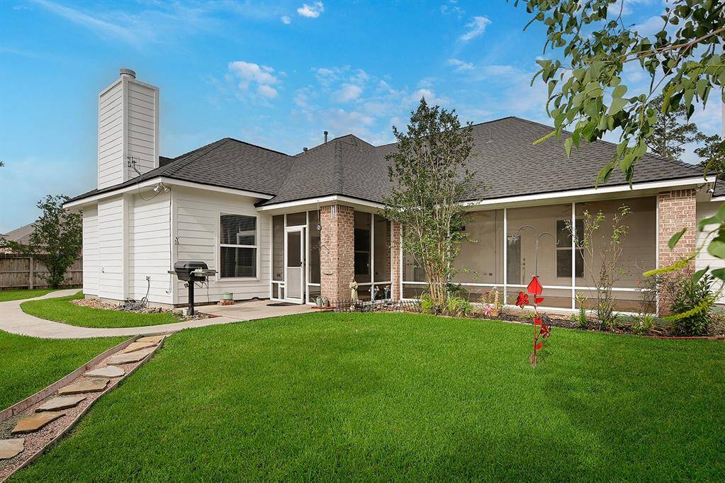 View of back of the house with screened in porch and grill area