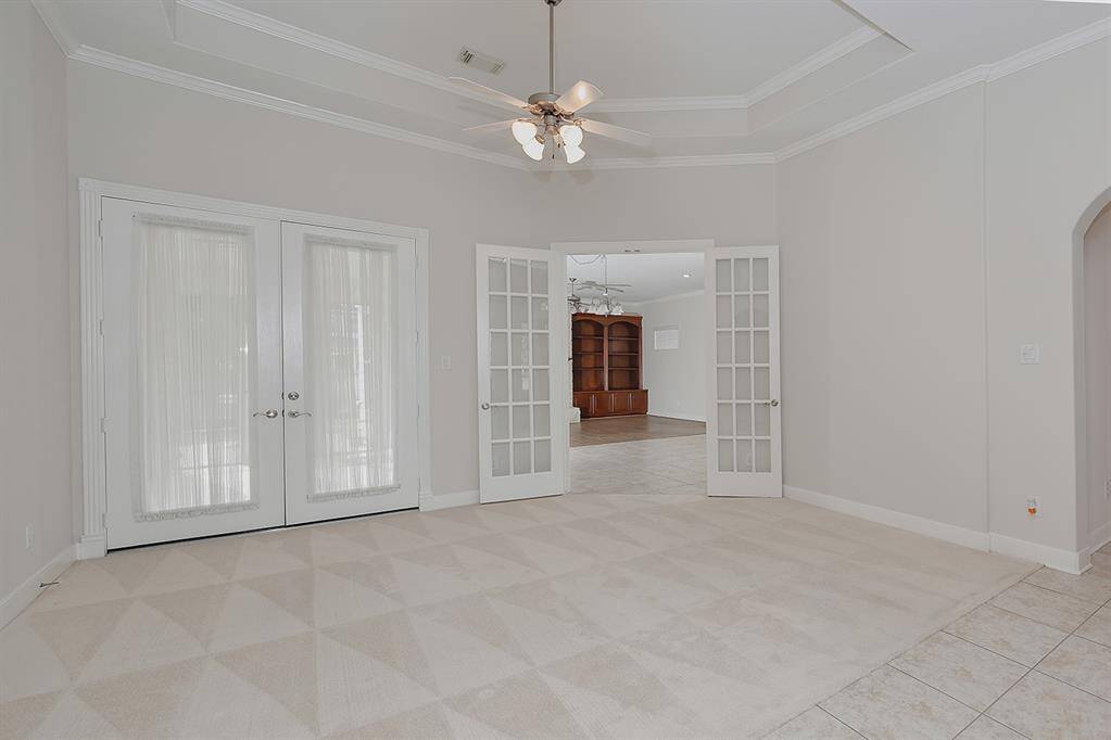 Living area with french doors to the great room and to the screened in porch