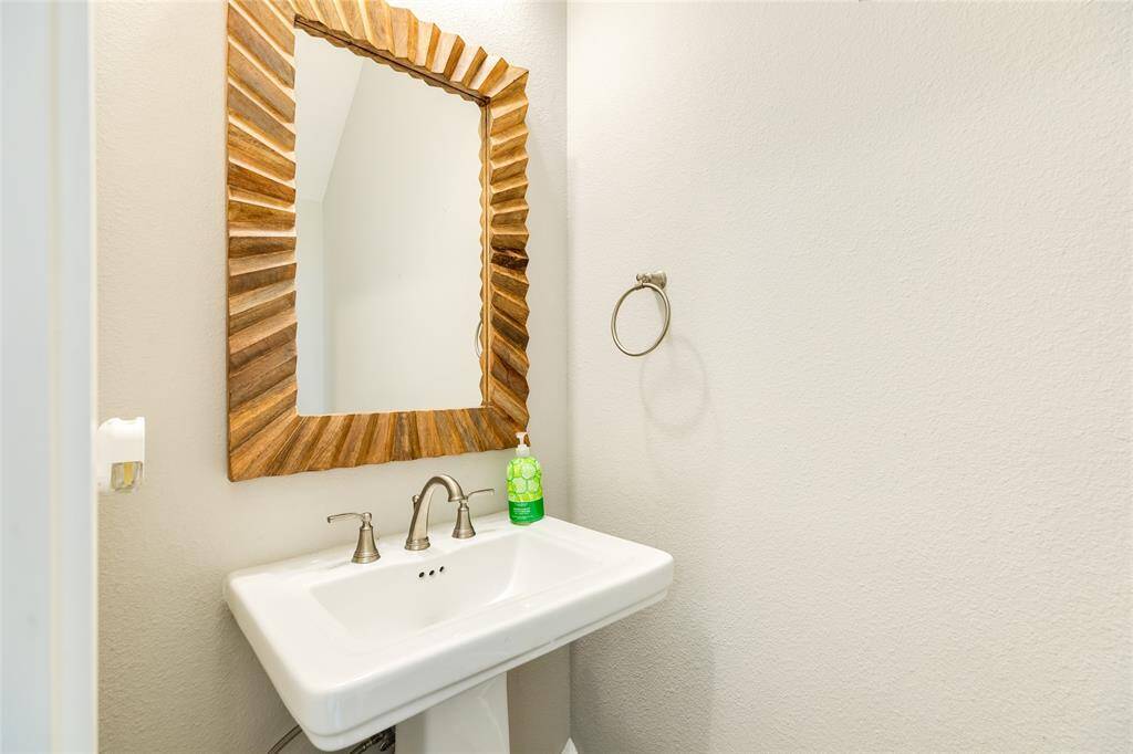 A half bath located just off the kitchen and laundry area is very convenient for guests and everyday use.