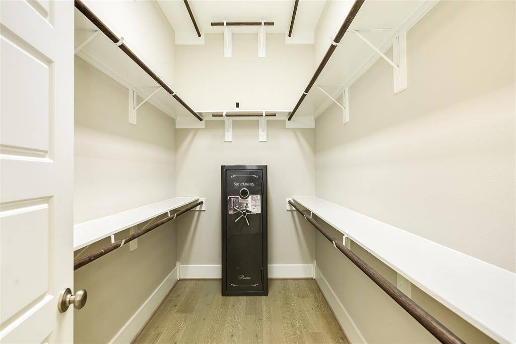 This primary closet is HUGE. The space offers room for everything and notice the full-size fire proof safe that remains with the property.