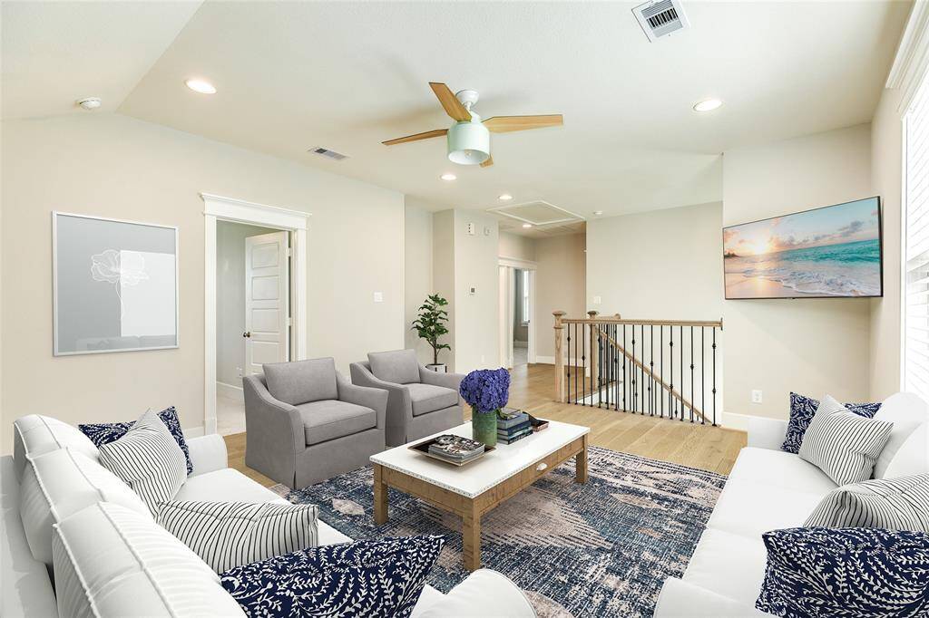 VIRTUALLY STAGED - Another view of the upstairs living/flex space. The bedroom door on the left is the upstairs suite (second primary).